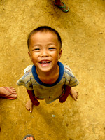 Boy surrounded; Ban NaKaang, Laos, 2009